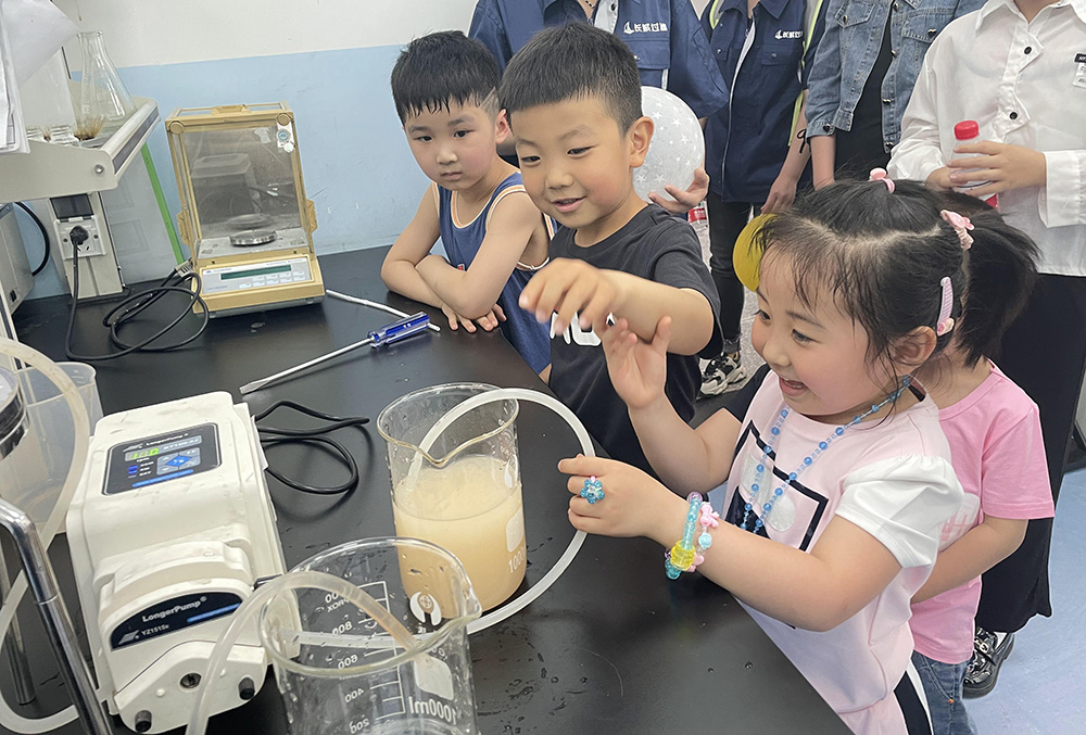 Children watching filtration experiment in laboratory
